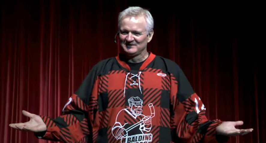 Pat Doyle on stage hands out