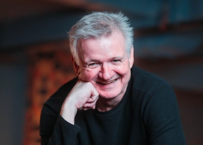 Pat Doyle smiling leaning on fist.